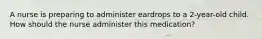 A nurse is preparing to administer eardrops to a 2-year-old child. How should the nurse administer this medication?