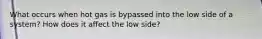 What occurs when hot gas is bypassed into the low side of a system? How does it affect the low side?