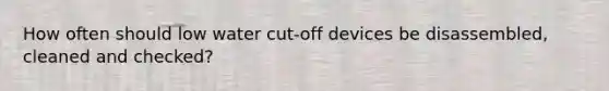 How often should low water cut-off devices be disassembled, cleaned and checked?