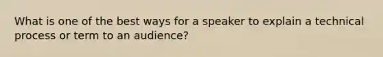 What is one of the best ways for a speaker to explain a technical process or term to an audience?