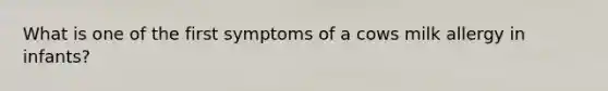 What is one of the first symptoms of a cows milk allergy in infants?