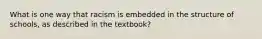 What is one way that racism is embedded in the structure of schools, as described in the textbook?