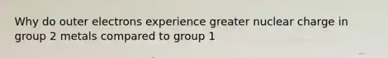 Why do outer electrons experience greater nuclear charge in group 2 metals compared to group 1