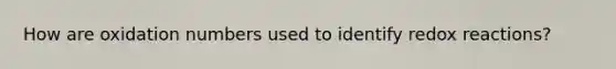 How are oxidation numbers used to identify redox reactions?