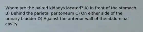 Where are the paired kidneys located? A) In front of the stomach B) Behind the parietal peritoneum C) On either side of the urinary bladder D) Against the anterior wall of the abdominal cavity