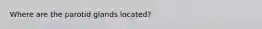 Where are the parotid glands located?