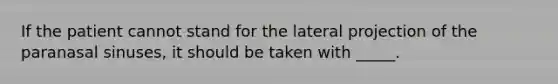 If the patient cannot stand for the lateral projection of the paranasal sinuses, it should be taken with _____.