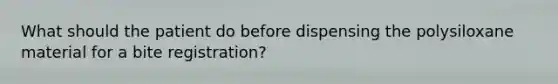 What should the patient do before dispensing the polysiloxane material for a bite registration?