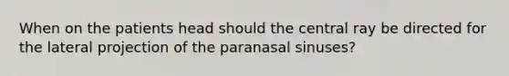 When on the patients head should the central ray be directed for the lateral projection of the paranasal sinuses?