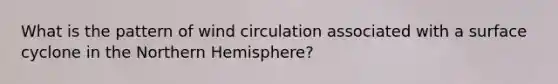 What is the pattern of wind circulation associated with a surface cyclone in the Northern Hemisphere?