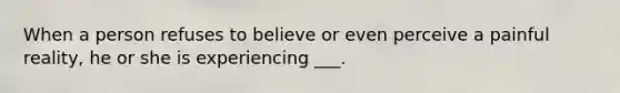 When a person refuses to believe or even perceive a painful reality, he or she is experiencing ___.