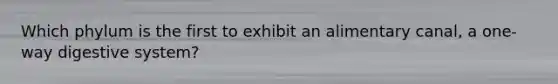 Which phylum is the first to exhibit an alimentary canal, a one-way digestive system?