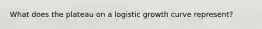 What does the plateau on a logistic growth curve represent?