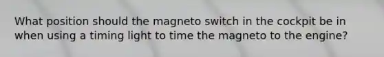 What position should the magneto switch in the cockpit be in when using a timing light to time the magneto to the engine?