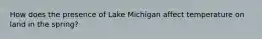 How does the presence of Lake Michigan affect temperature on land in the spring?