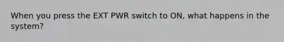 When you press the EXT PWR switch to ON, what happens in the system?