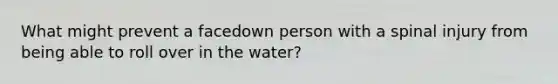 What might prevent a facedown person with a spinal injury from being able to roll over in the water?