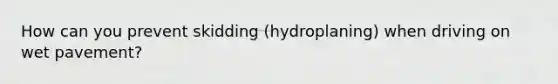 How can you prevent skidding (hydroplaning) when driving on wet pavement?