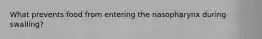 What prevents food from entering the nasopharynx during swalling?