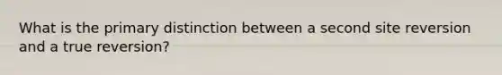 What is the primary distinction between a second site reversion and a true reversion?