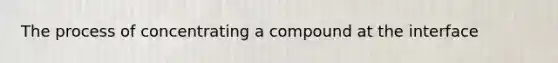 The process of concentrating a compound at the interface