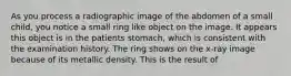 As you process a radiographic image of the abdomen of a small child, you notice a small ring like object on the image. It appears this object is in the patients stomach, which is consistent with the examination history. The ring shows on the x-ray image because of its metallic density. This is the result of