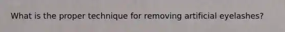 What is the proper technique for removing artificial eyelashes?