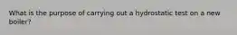 What is the purpose of carrying out a hydrostatic test on a new boiler?