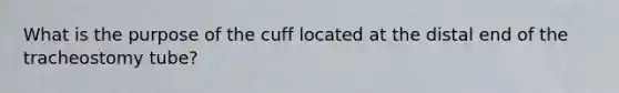 What is the purpose of the cuff located at the distal end of the tracheostomy tube?