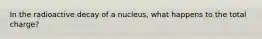 In the radioactive decay of a nucleus, what happens to the total charge?