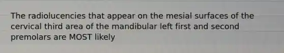 The radiolucencies that appear on the mesial surfaces of the cervical third area of the mandibular left first and second premolars are MOST likely