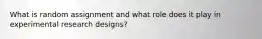What is random assignment and what role does it play in experimental research designs?