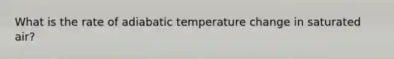 What is the rate of adiabatic temperature change in saturated air?