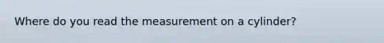 Where do you read the measurement on a cylinder?