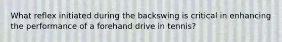 What reflex initiated during the backswing is critical in enhancing the performance of a forehand drive in tennis?