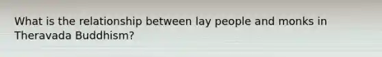 What is the relationship between lay people and monks in Theravada Buddhism?