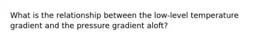 What is the relationship between the low-level temperature gradient and the pressure gradient aloft?