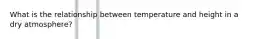 What is the relationship between temperature and height in a dry atmosphere?