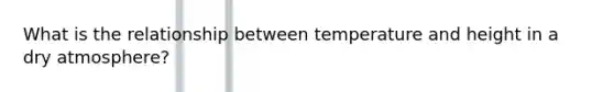 What is the relationship between temperature and height in a dry atmosphere?