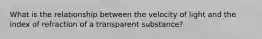 What is the relationship between the velocity of light and the index of refraction of a transparent substance?