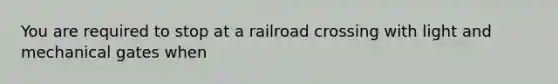 You are required to stop at a railroad crossing with light and mechanical gates when