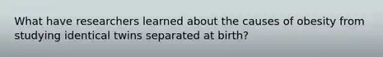 What have researchers learned about the causes of obesity from studying identical twins separated at birth?