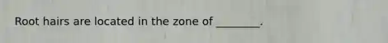 Root hairs are located in the zone of ________.