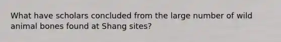 What have scholars concluded from the large number of wild animal bones found at Shang sites?