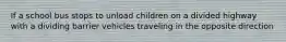 If a school bus stops to unload children on a divided highway with a dividing barrier vehicles traveling in the opposite direction