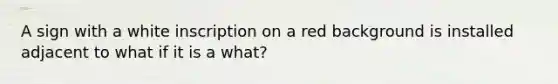 A sign with a white inscription on a red background is installed adjacent to what if it is a what?