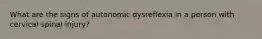 What are the signs of autonomic dysreflexia in a person with cervical spinal injury?