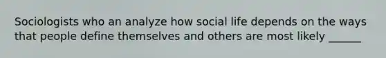 Sociologists who an analyze how social life depends on the ways that people define themselves and others are most likely ______