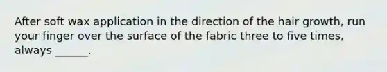After soft wax application in the direction of the hair growth, run your finger over the surface of the fabric three to five times, always ______.