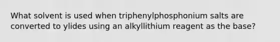 What solvent is used when triphenylphosphonium salts are converted to ylides using an alkyllithium reagent as the base?